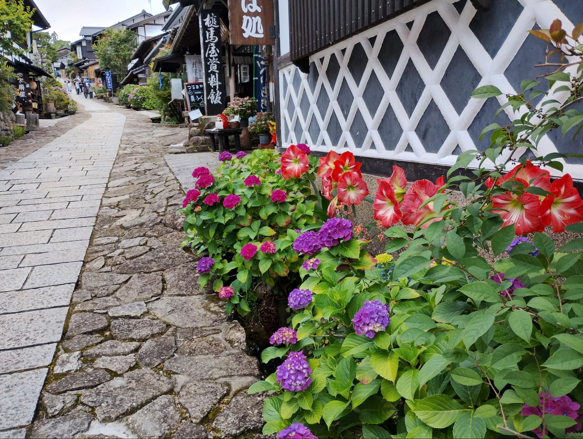 The stone-paved street of Magome lined with flowers
