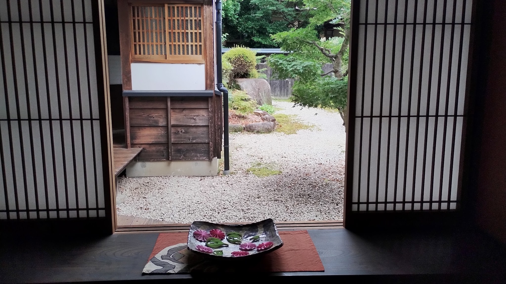 Seasonal flowers arranged beside a view of the garden